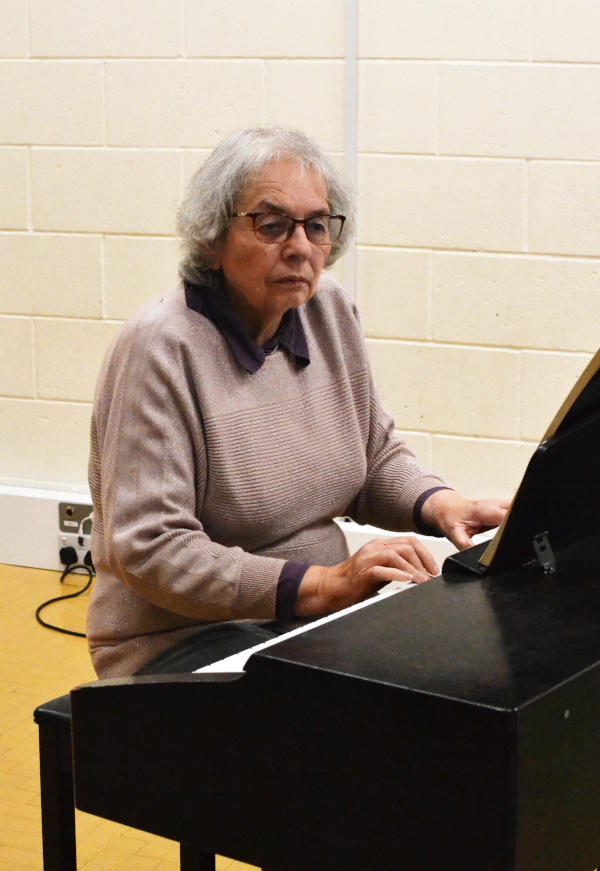 Miriam sitting playing a digital piano