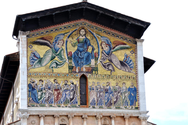 High outer end wall of a cathedral painted with a mural of Jesus and the twelve apostles